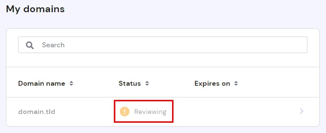 The Domains section of Hostinger Members Area showing a domain with Reviewing Status