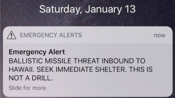 Emergency alert message on a phone screen warning of a ballistic missile threat to Hawaii, urging immediate shelter.